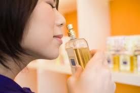 Woman Smelling Perfume photo Smelling.jpg